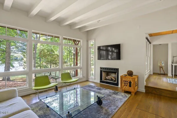a view of a livingroom with furniture and a large window