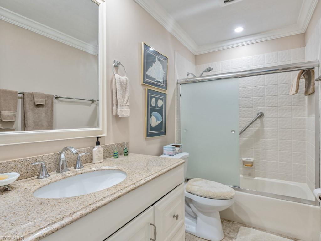 594 Augusta Boulevard, Unit 3 Naples, FL 34113 - Photo 11 of 20 a bathroom with a granite countertop sink toilet and shower