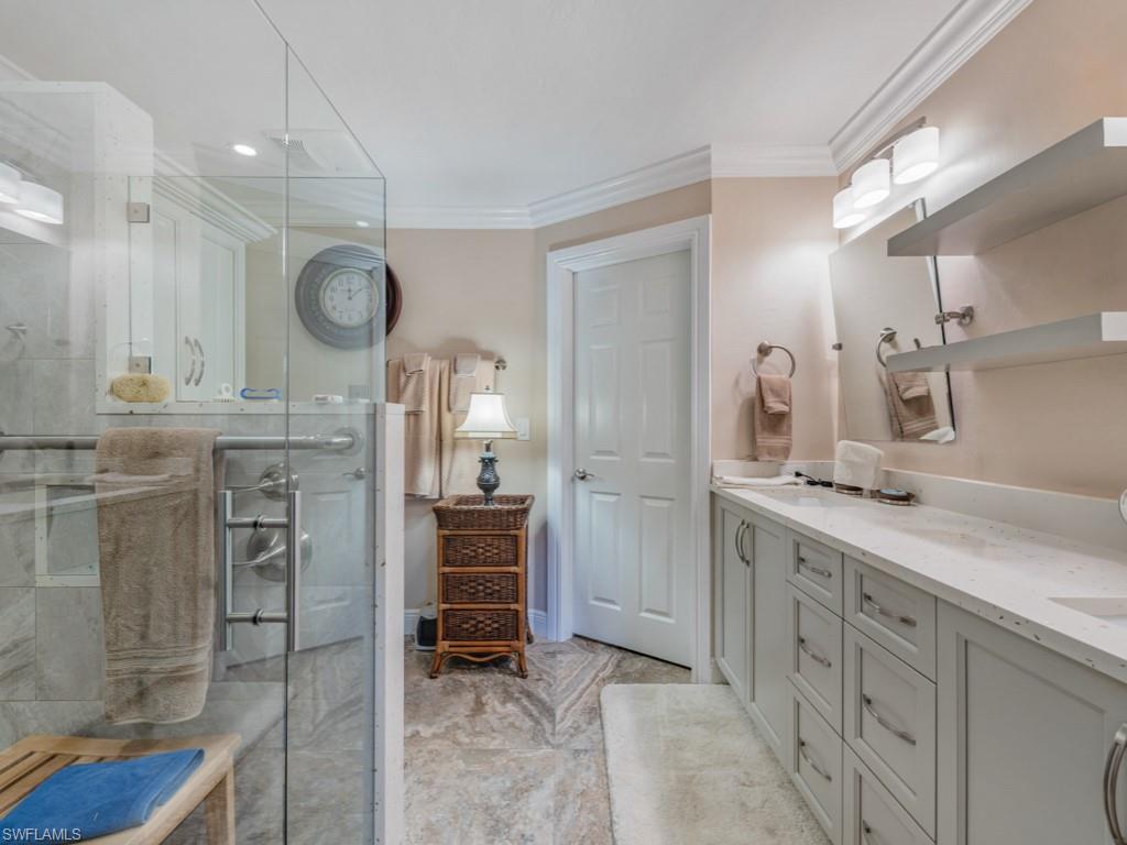 594 Augusta Boulevard, Unit 3 Naples, FL 34113 - Photo 14 of 20 a kitchen with cabinets and chairs