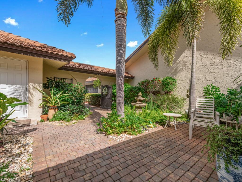 594 Augusta Boulevard, Unit 3 Naples, FL 34113 - Photo 16 of 20 a view of a house with a yard