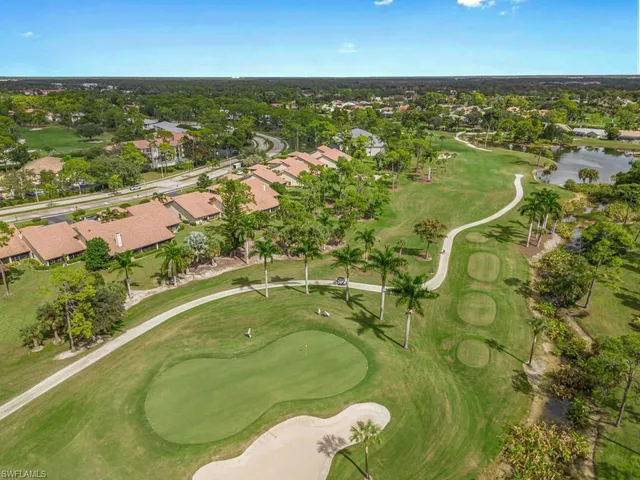 an aerial view of residential houses with outdoor space and swimming pool