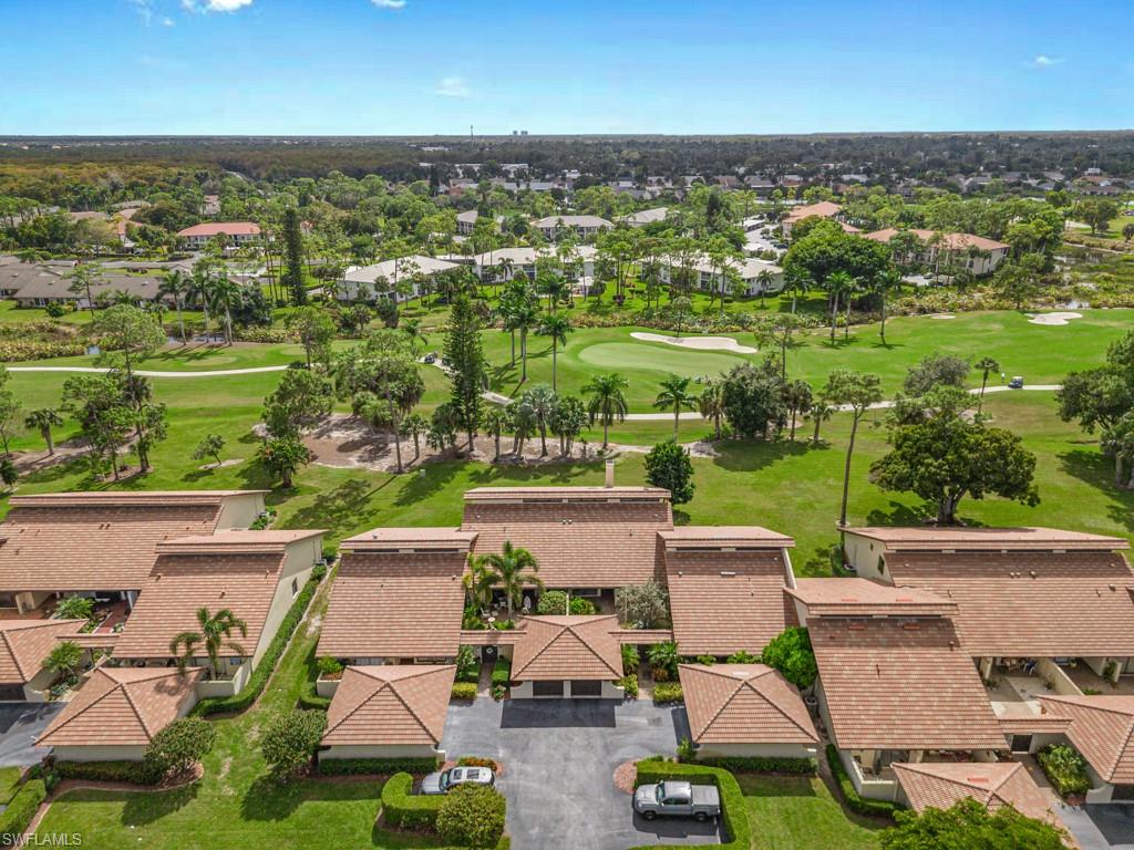 594 Augusta Boulevard, Unit 3 Naples, FL 34113 - Photo 2 of 20 an aerial view of residential houses with outdoor space and parking
