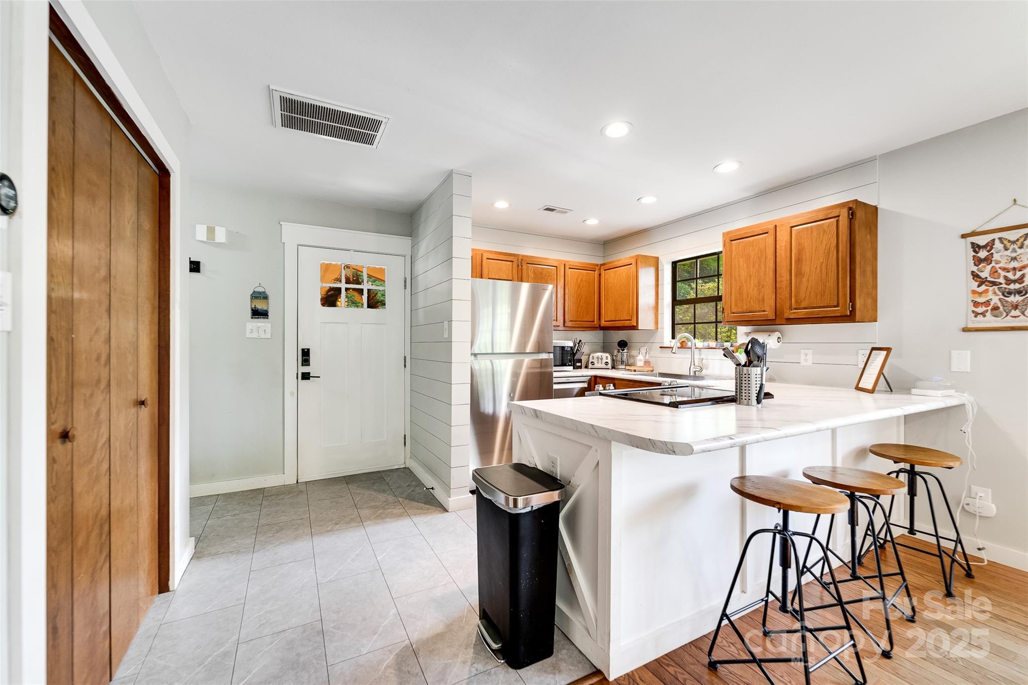 125 Nugget Lane Sylva, NC 28779 - Photo 11 of 30 a kitchen with a sink a refrigerator and chairs