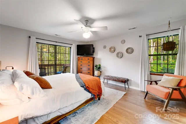a living room with furniture a flat screen tv and a large window