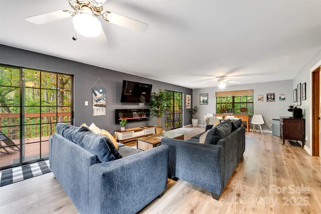 a dining room with furniture a chandelier and wooden floor
