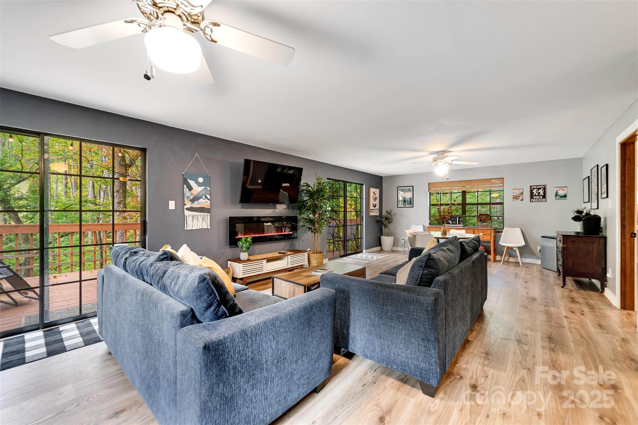 125 Nugget Lane Sylva, NC 28779 - Photo 14 of 30 a living room with furniture a flat screen tv and a large window