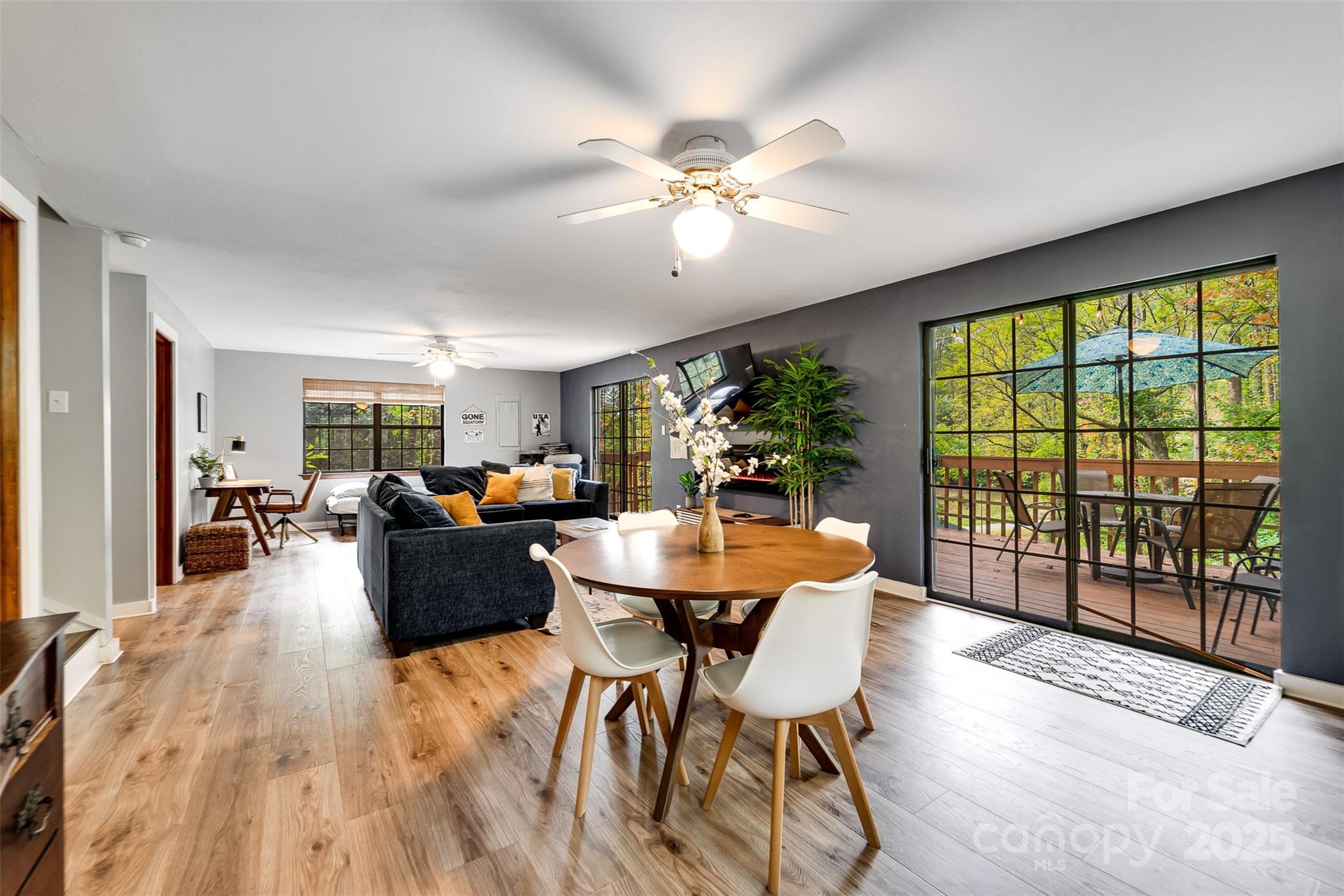 125 Nugget Lane Sylva, NC 28779 - Photo 16 of 30 a dining room with furniture a chandelier and wooden floor