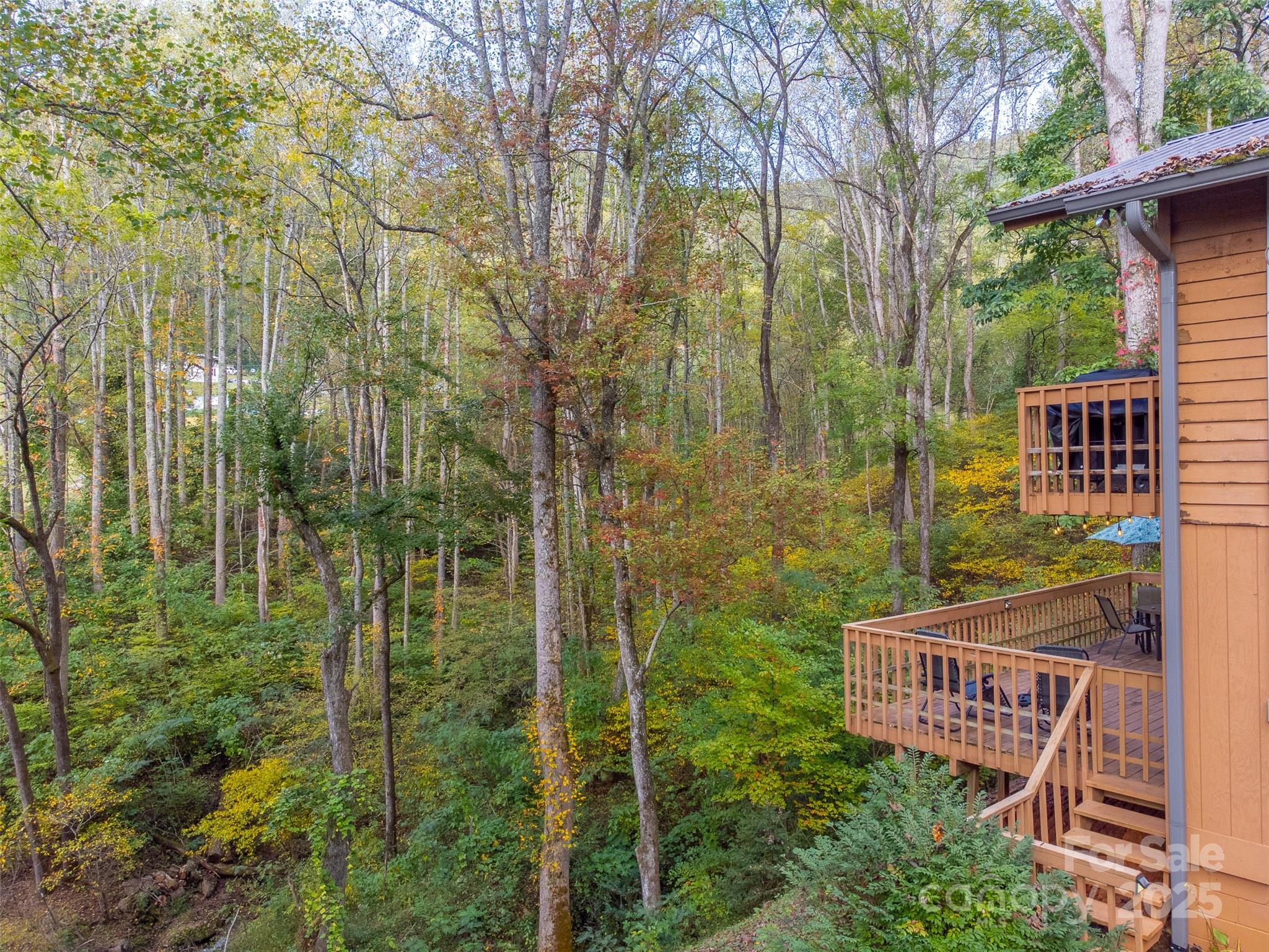 125 Nugget Lane Sylva, NC 28779 - Photo 28 of 30 a view of a wooden balcony with a tree