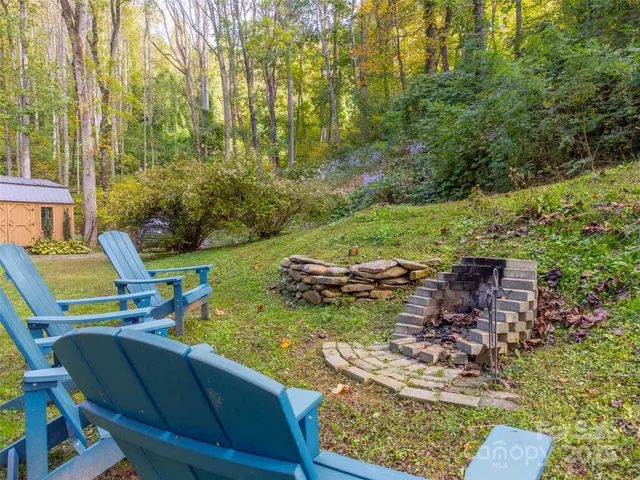 a view of backyard with seating area and trees