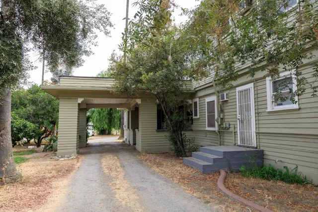 a front view of a house with car parked