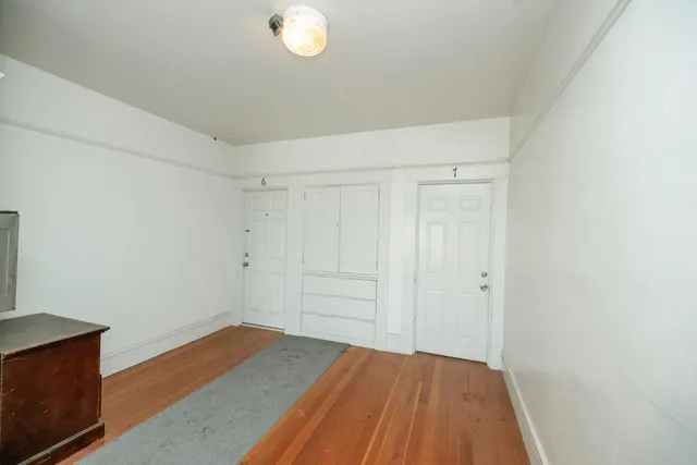 a living room with furniture a flat screen tv and a window