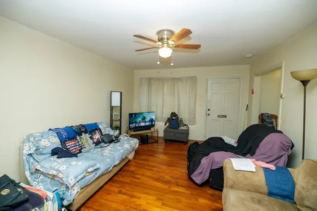 a kitchen with a refrigerator a stove and a wooden floor