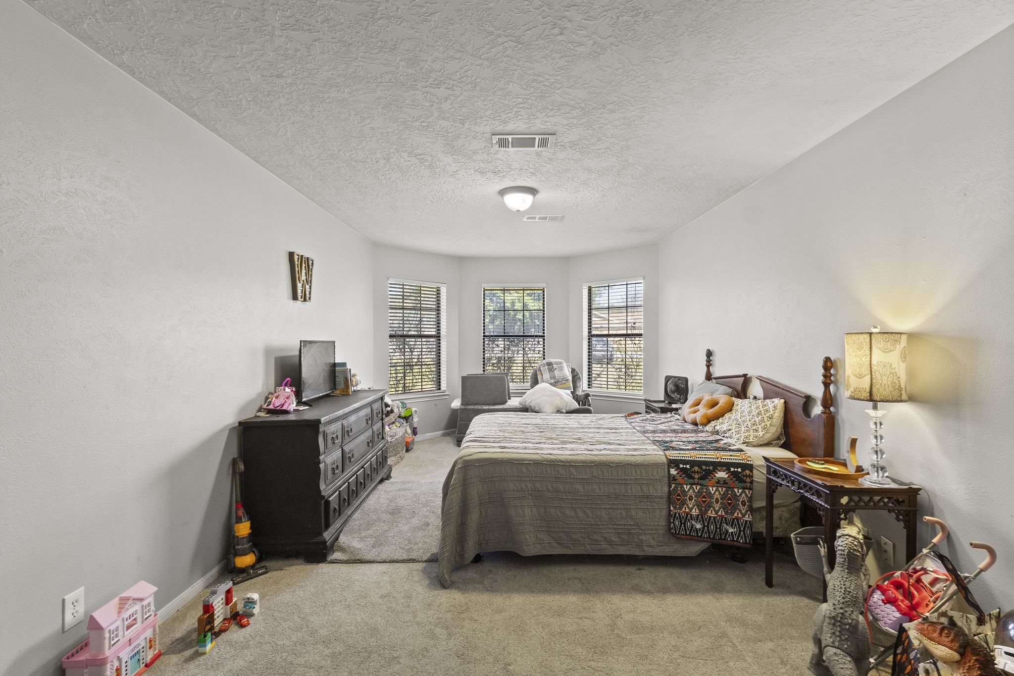 125 Williams Road Lumberton, TX 77657 - Photo 12 of 22 a bedroom with a bed gym equipment and view of living room
