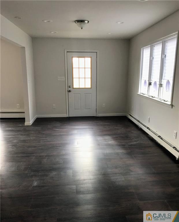 473 Harding Road Old Bridge, NJ 08879 - Photo 14 of 24 an empty room with wooden floor and windows
