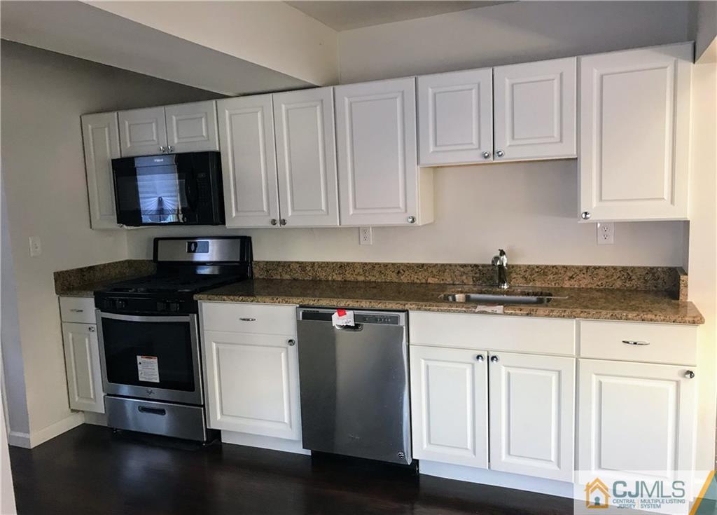 473 Harding Road Old Bridge, NJ 08879 - Photo 8 of 24 a kitchen with granite countertop white cabinets and a stove