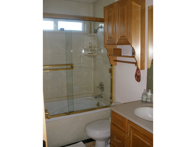 61 Ralston Ranch Road Belmont, CA 94002 - Photo 10 of 13 a bathroom with a granite countertop toilet a sink and a mirror