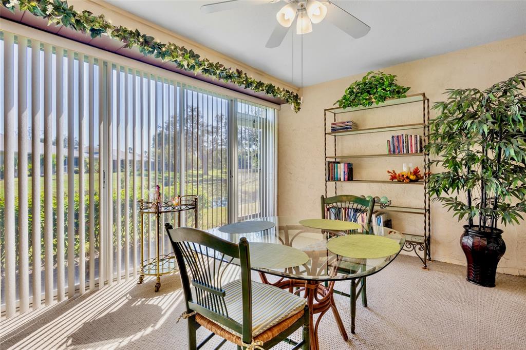 3905 Center Gate Circle, Unit 3 Sarasota, FL 34233 - Photo 12 of 20 a view of a dining room with furniture window and wooden floor