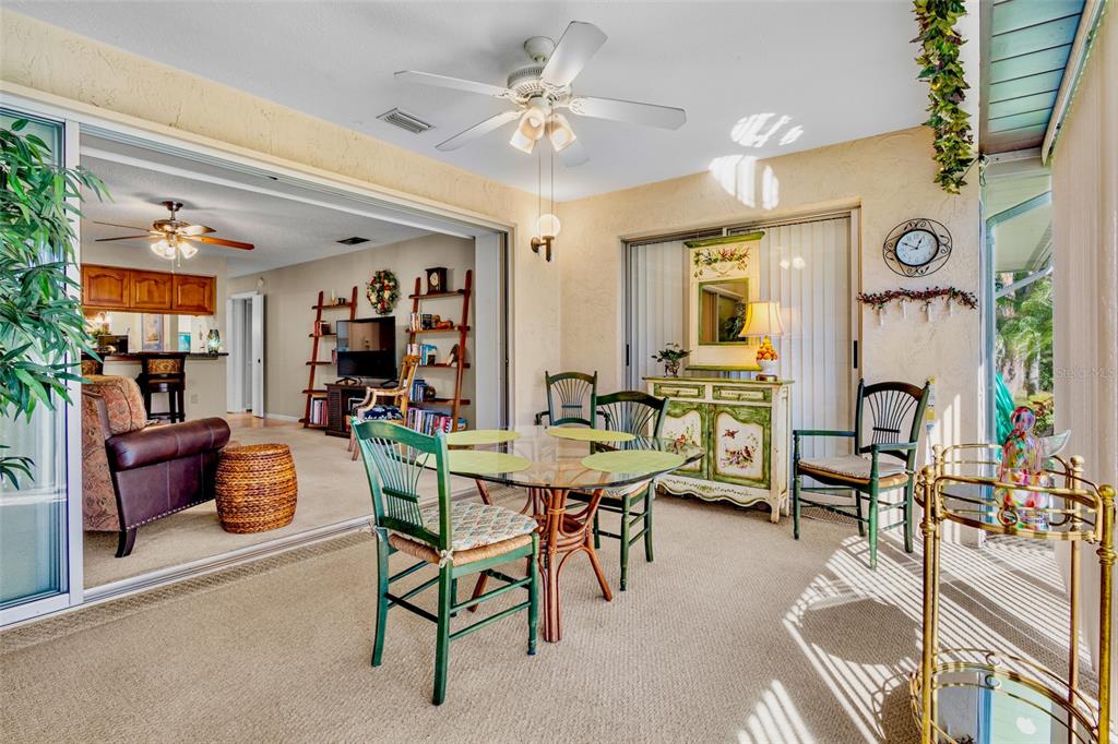 3905 Center Gate Circle, Unit 3 Sarasota, FL 34233 - Photo 13 of 20 a living room with furniture and a chandelier