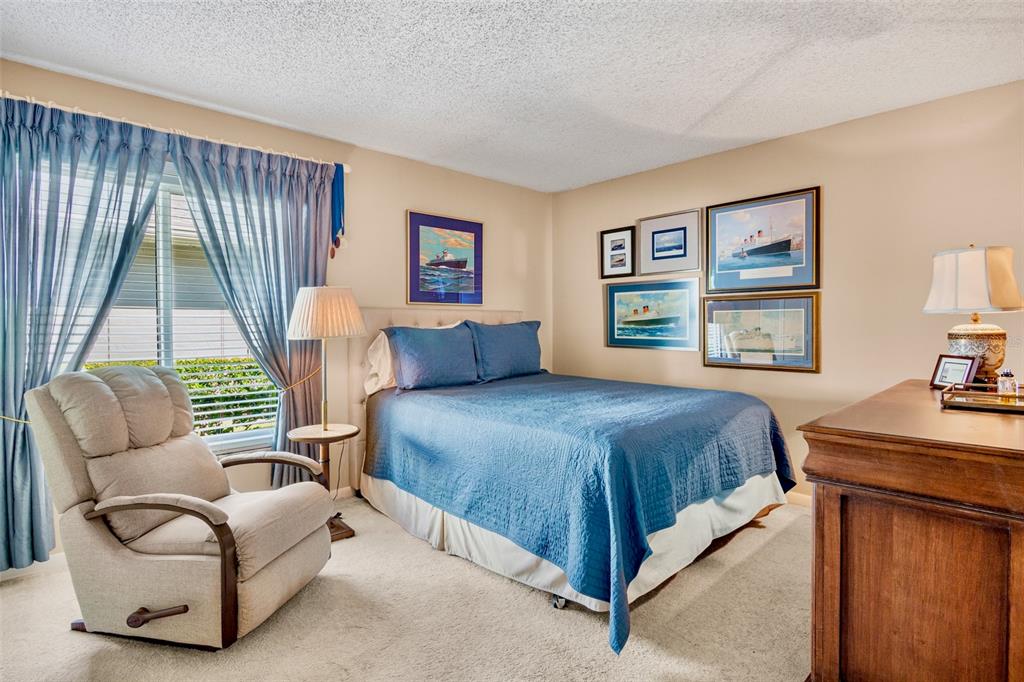 3905 Center Gate Circle, Unit 3 Sarasota, FL 34233 - Photo 14 of 20 a bedroom with a large bed and a couch