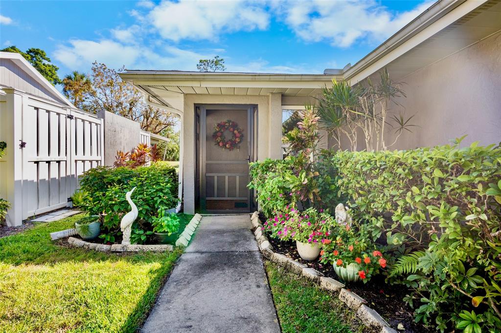 3905 Center Gate Circle, Unit 3 Sarasota, FL 34233 - Photo 2 of 20 a front view of a house with a yard