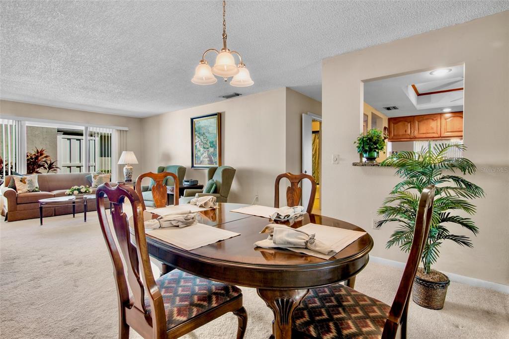 3905 Center Gate Circle, Unit 3 Sarasota, FL 34233 - Photo 4 of 20 a view of a dining room with furniture and wooden floor