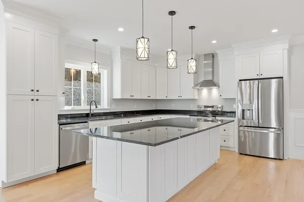 a kitchen with granite countertop a sink stainless steel appliances and cabinets