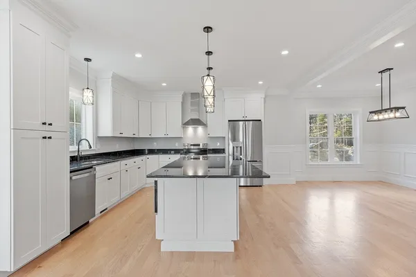 a view of empty room with wooden floor and fireplace