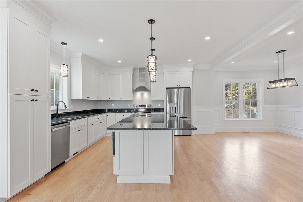 171 Upper Gore Road Webster, MA 01570 - Photo 13 of 42 a kitchen with stainless steel appliances kitchen island granite countertop a sink a stove a refrigerator and white cabinets with wooden floor