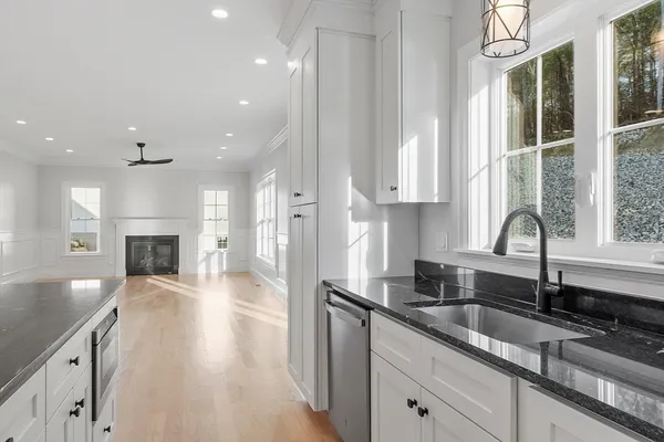 a spacious bathroom with a granite countertop sink mirror and shower