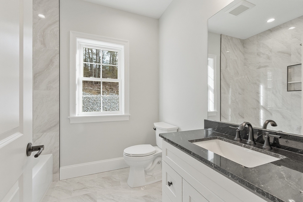 171 Upper Gore Road Webster, MA 01570 - Photo 35 of 42 a bathroom with a granite countertop sink a toilet and a mirror