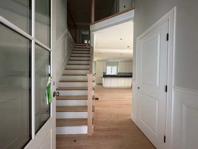 a view of a hallway with wooden floor and entryway