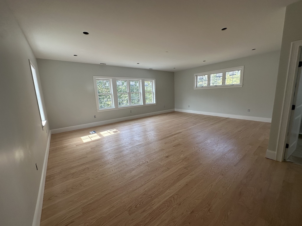 171 Upper Gore Road Webster, MA 01570 - Photo 9 of 11 an empty room with wooden floor and windows