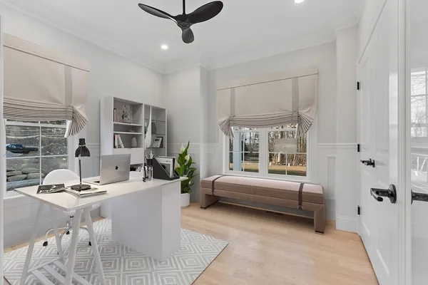 a kitchen with stainless steel appliances kitchen island granite countertop a sink a stove a refrigerator and white cabinets with wooden floor