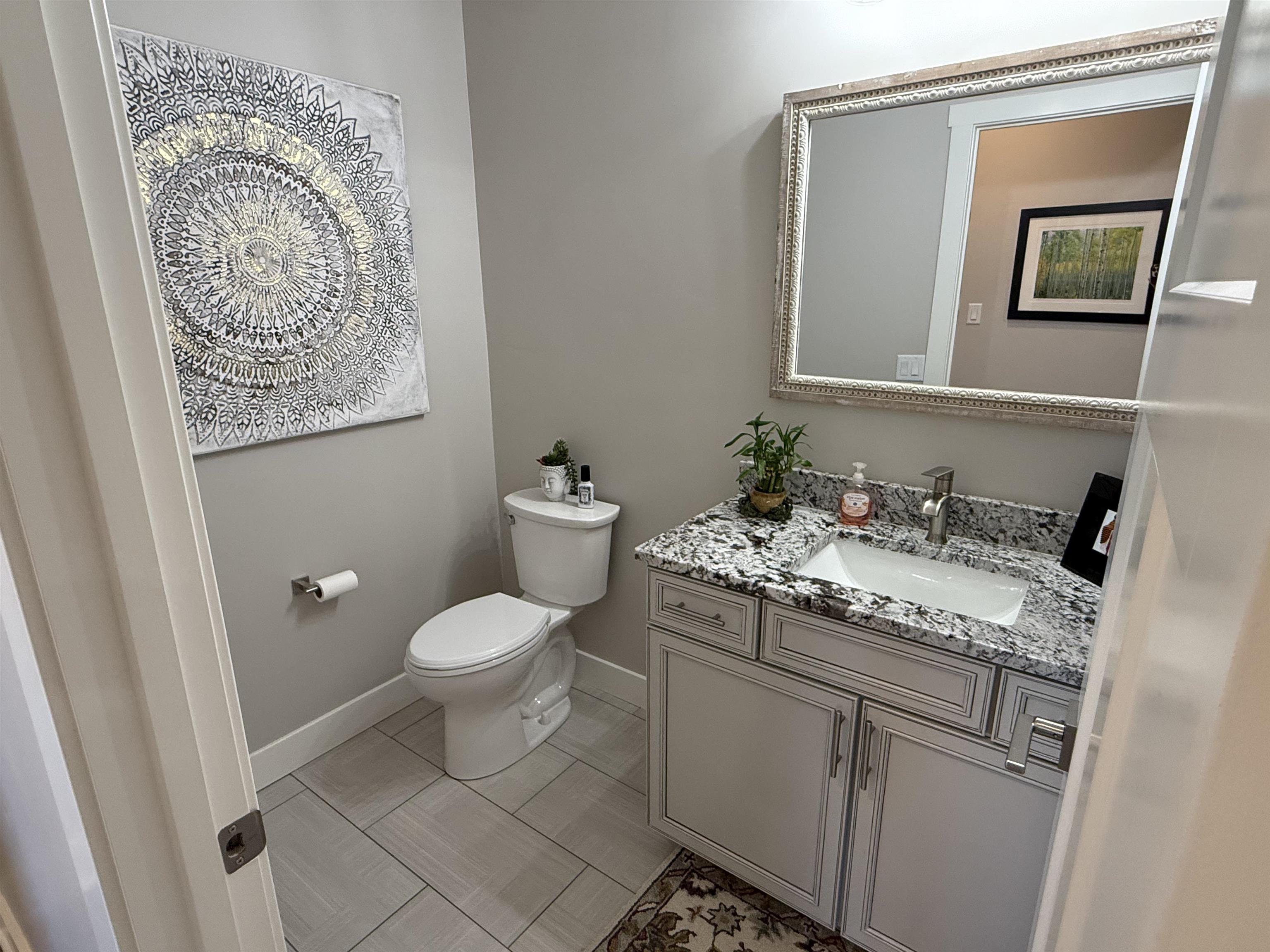 1210 Fairway Drive Fruita, CO 81521 - Photo 12 of 33 a bathroom with a granite countertop sink mirror vanity and toilet