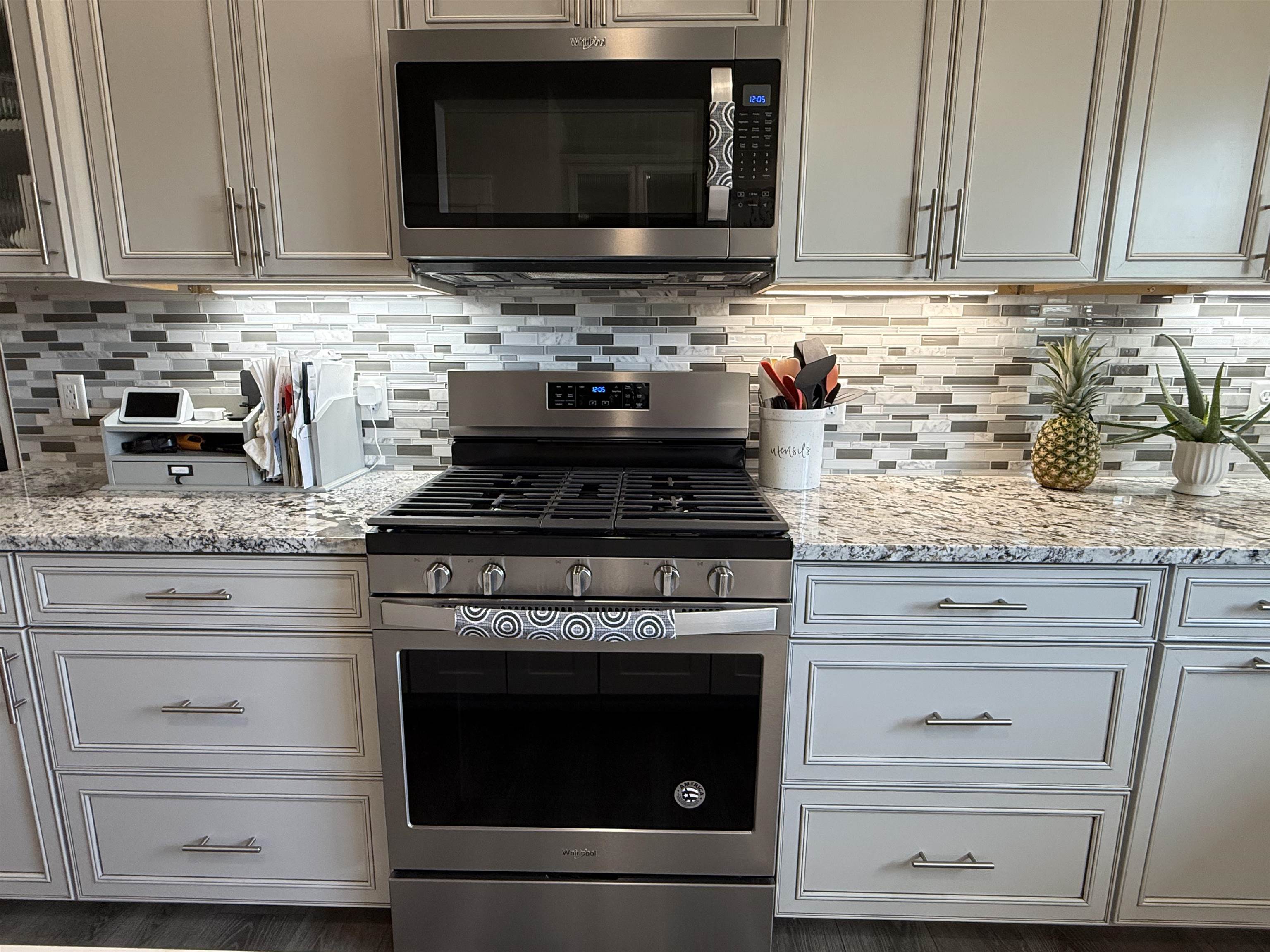 1210 Fairway Drive Fruita, CO 81521 - Photo 20 of 33 a kitchen with granite countertop a stove microwave and cabinets