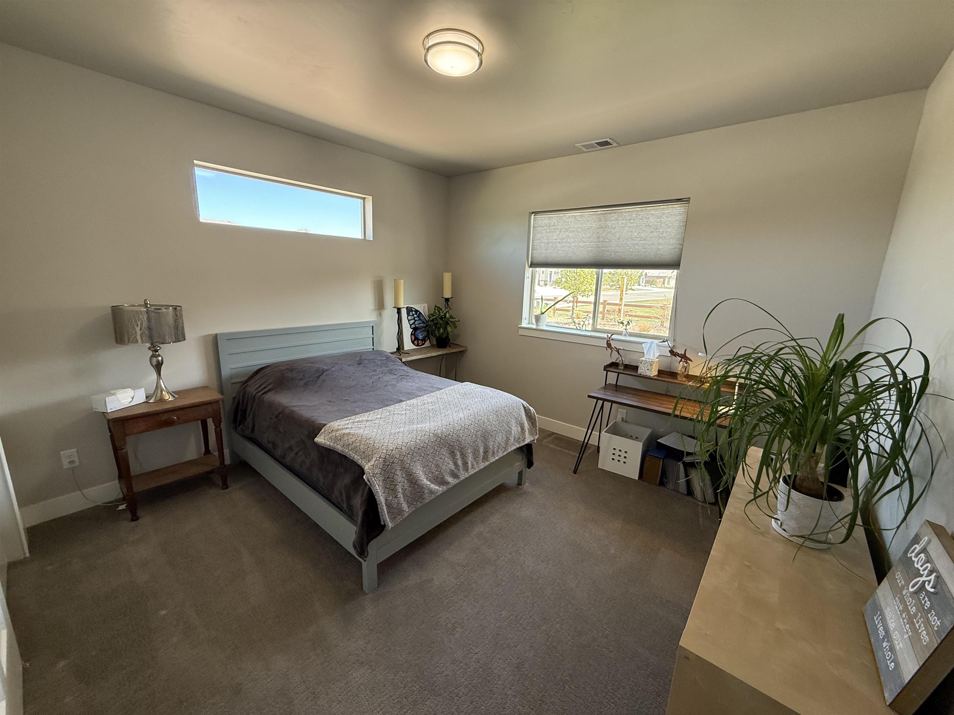 1210 Fairway Drive Fruita, CO 81521 - Photo 28 of 33 a bedroom with a bed table chair and a window