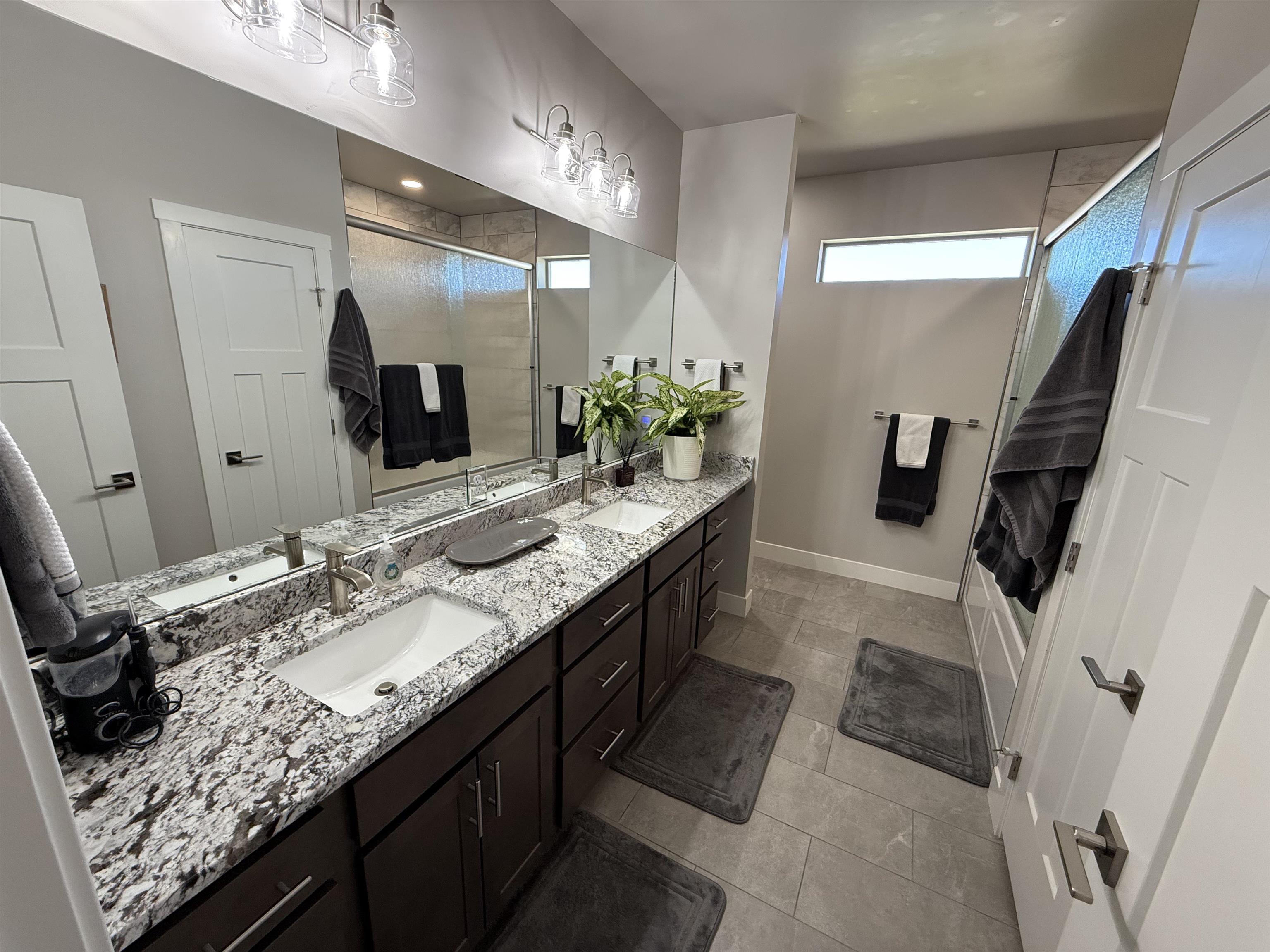 1210 Fairway Drive Fruita, CO 81521 - Photo 30 of 33 a bathroom with a granite countertop sink and a mirror