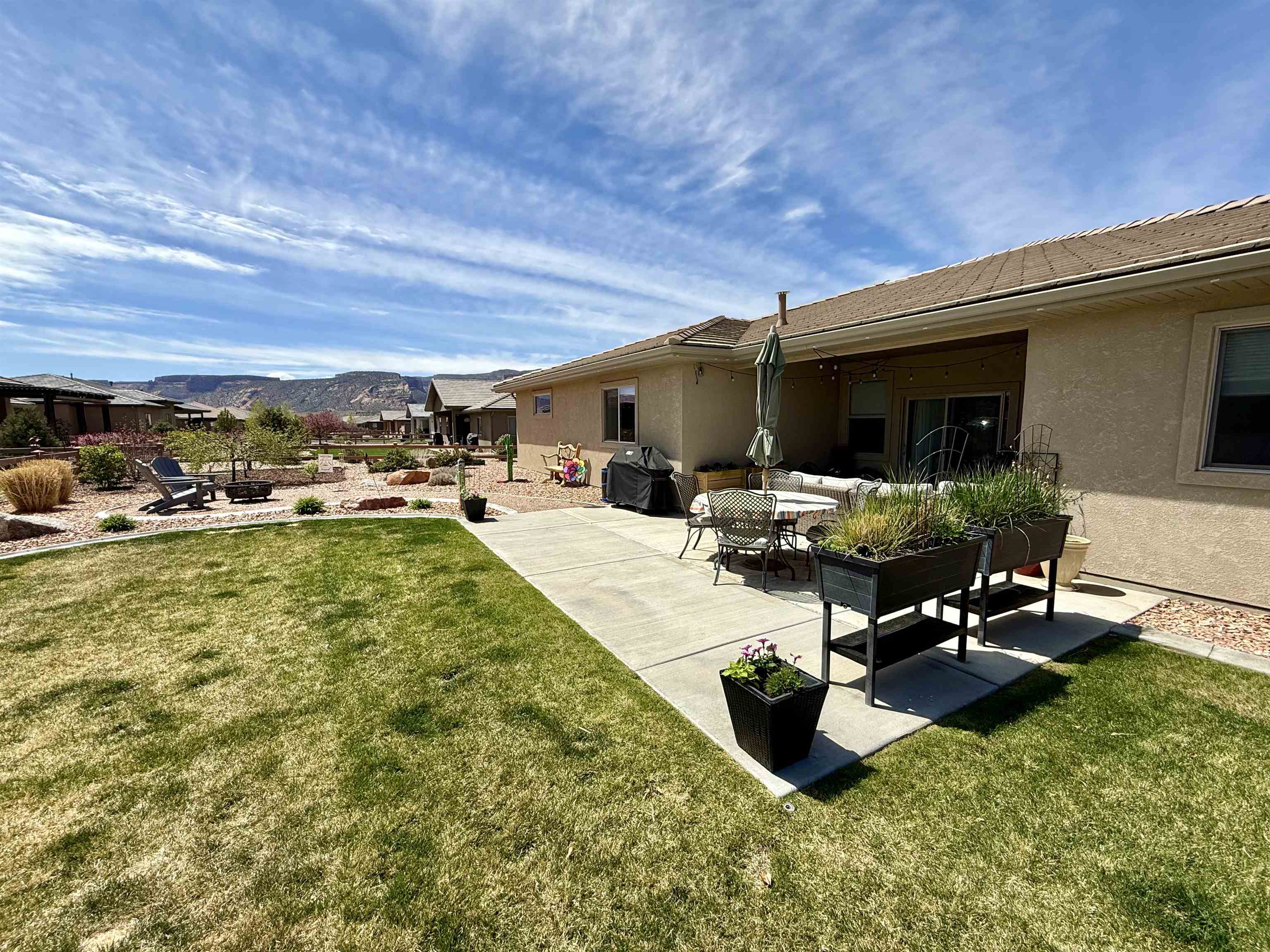 1210 Fairway Drive Fruita, CO 81521 - Photo 5 of 33 a view of swimming pool with outdoor seating and a garden