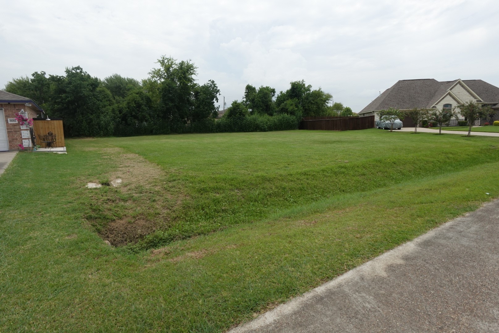 0 Violet View Drive Highlands, TX 77562 - Photo 2 of 7 a view of a green field with trees in the background