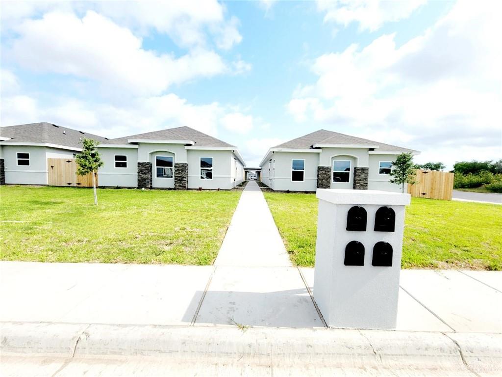 2109 Stauffer Street, Unit 4 Weslaco, TX 78596 - Photo 1 of 14 a view of residential houses with swimming pool and city view