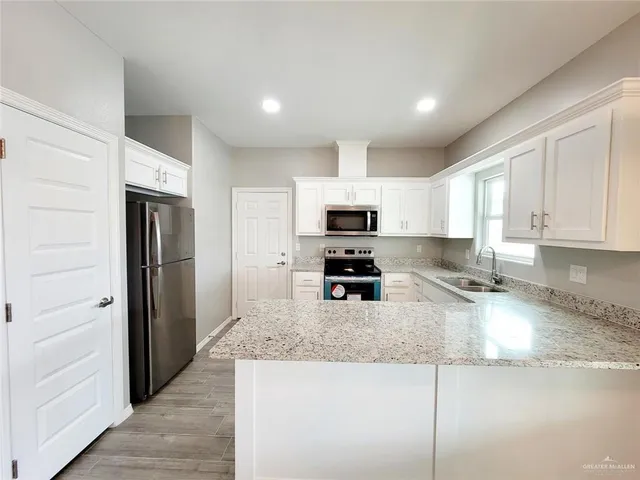 a view of kitchen with furniture and wooden floor