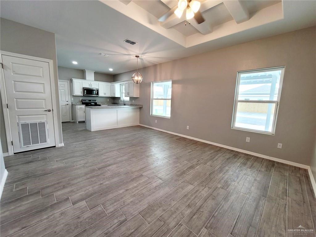 2109 Stauffer Street, Unit 4 Weslaco, TX 78596 - Photo 4 of 14 a view of kitchen with furniture and wooden floor