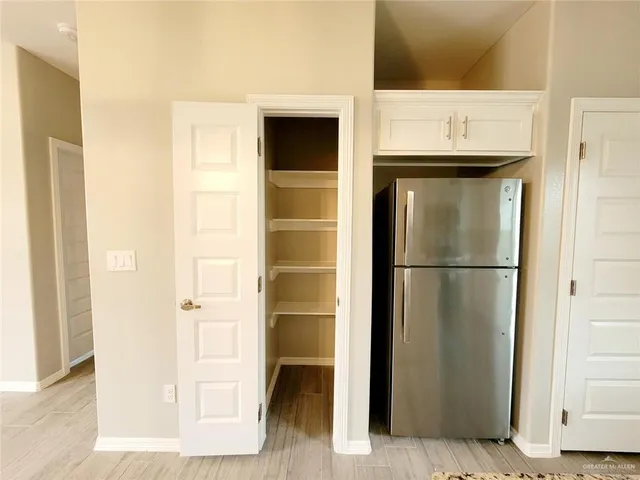 a view of a hallway with wooden floor and entryway