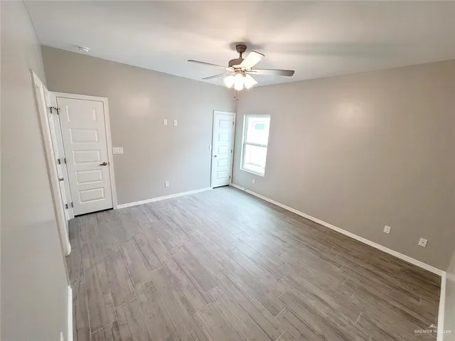 a bathroom with a granite countertop toilet sink and mirror