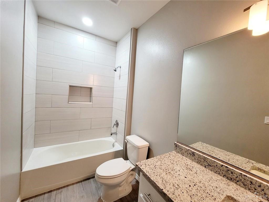 2109 Stauffer Street, Unit 4 Weslaco, TX 78596 - Photo 9 of 14 a bathroom with a sink a toilet and shower