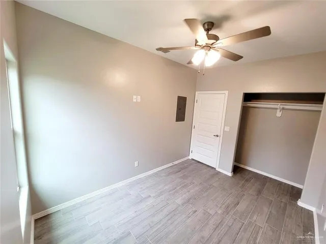 a view of an empty room with wooden fence