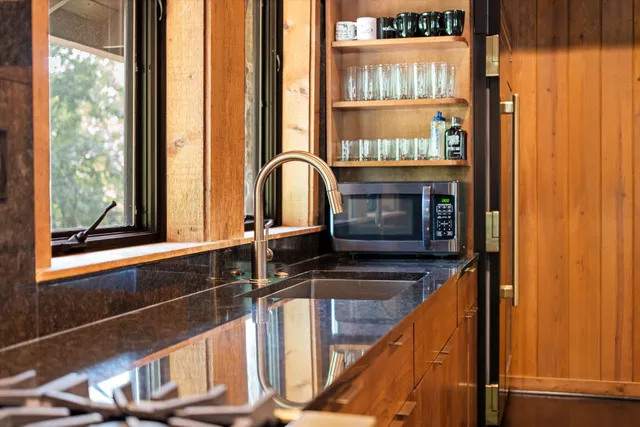 a kitchen with stainless steel appliances granite countertop a stove and cabinets