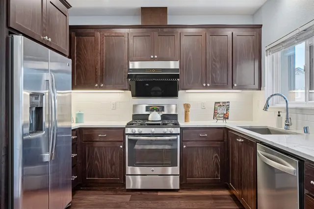 a kitchen with a sink stove and refrigerator