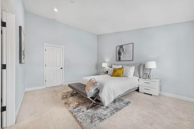 a bedroom with a bed and a painting on the wall