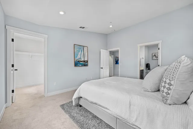 a bedroom with a bed and a painting